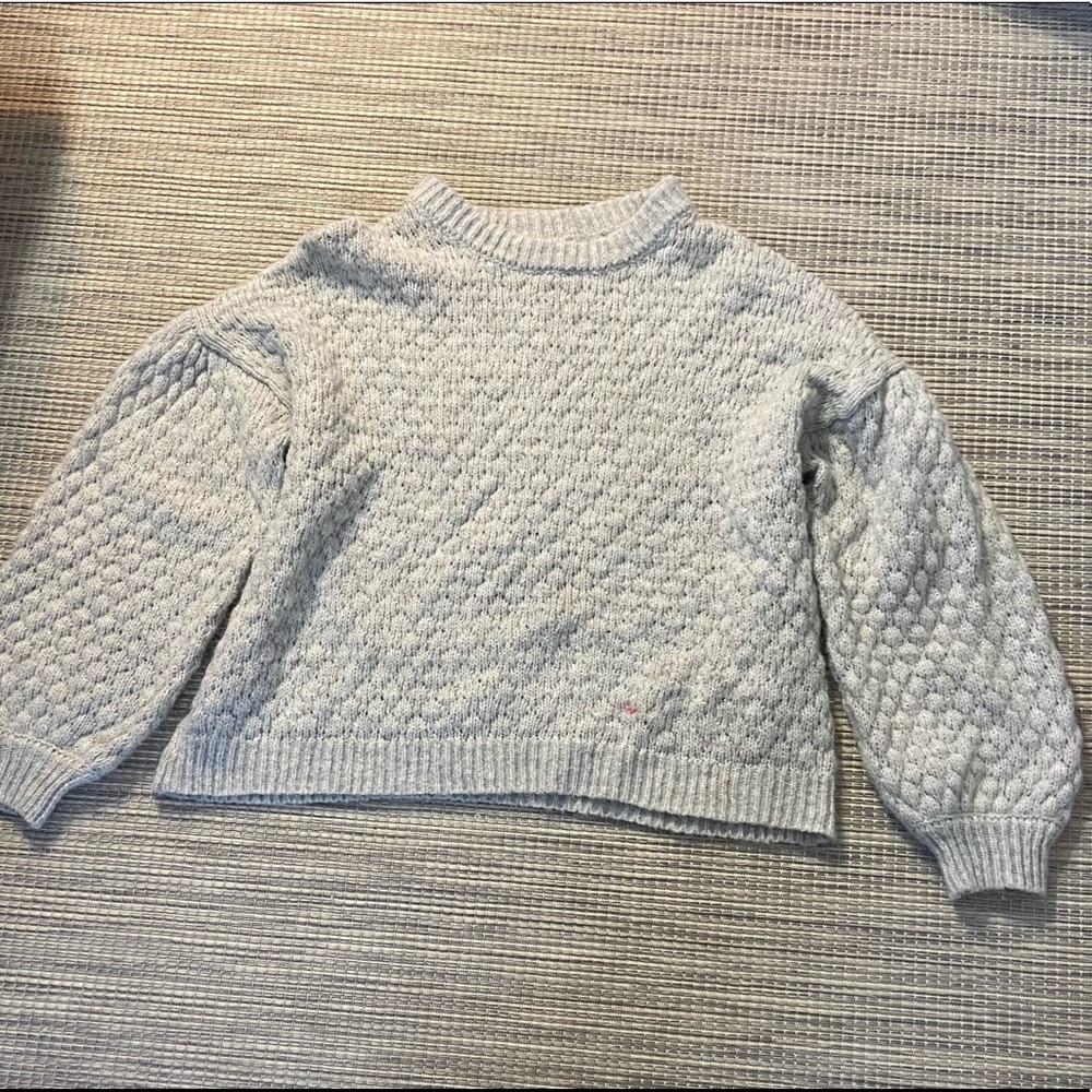 grey fluffy sweater.